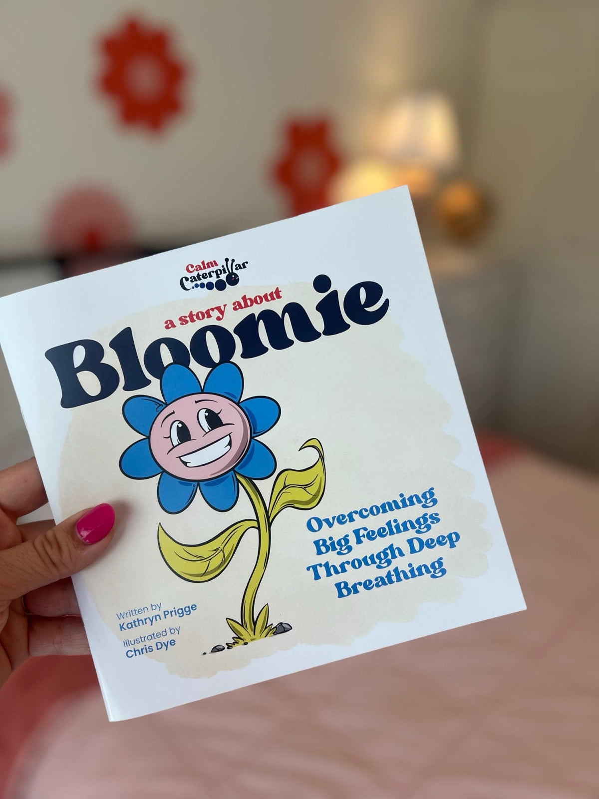 A hand holding Bloomie Book