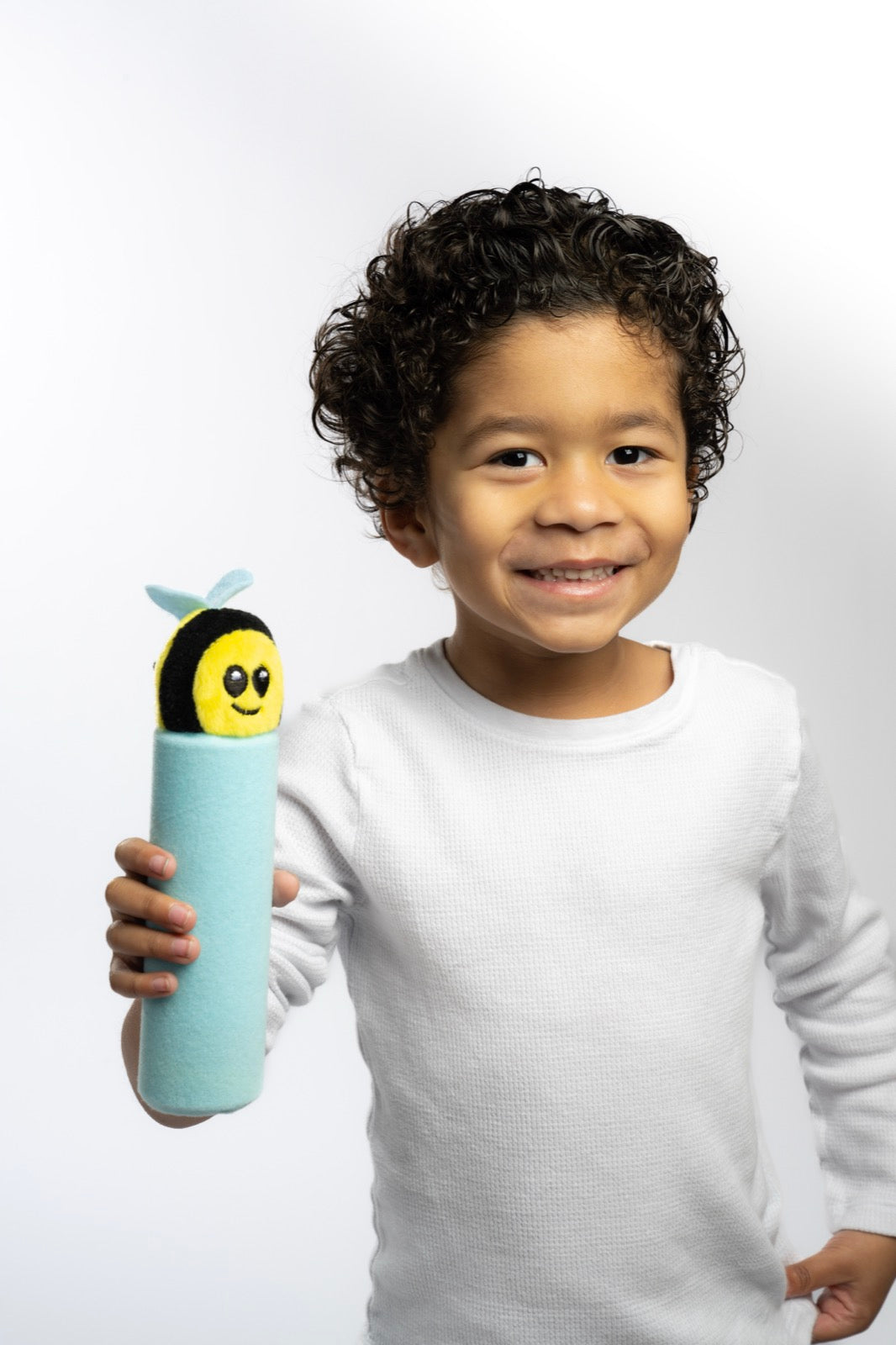 A boy holding Buzzee up to his face