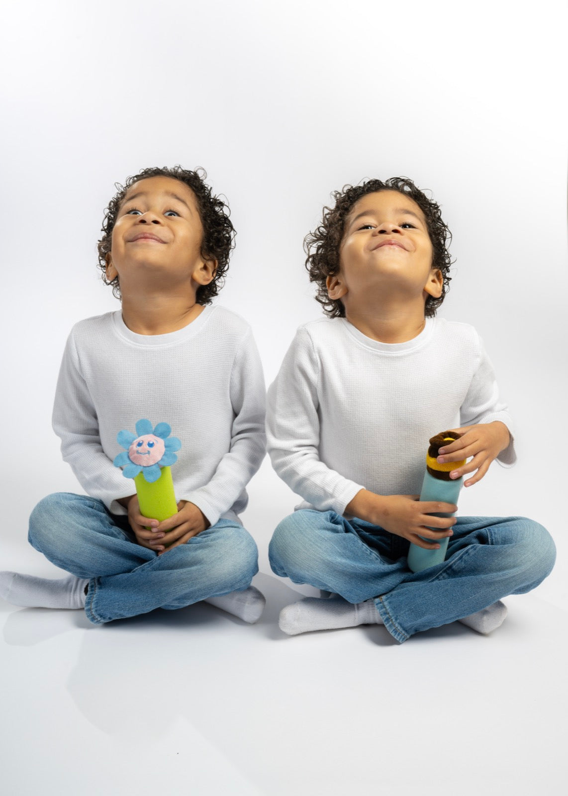 Two children each holding a Buzzee breathing stick