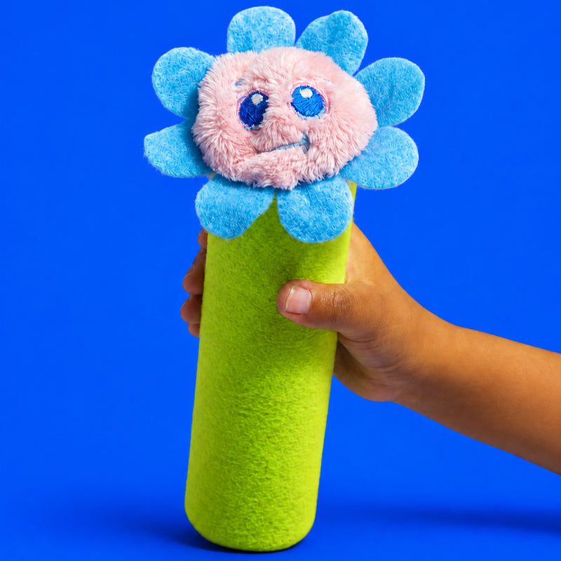 A child's hand holding Bloomie upright by the green stem