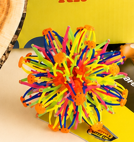 The expandable breathing ball, a multicoloured lattice sphere, opened out