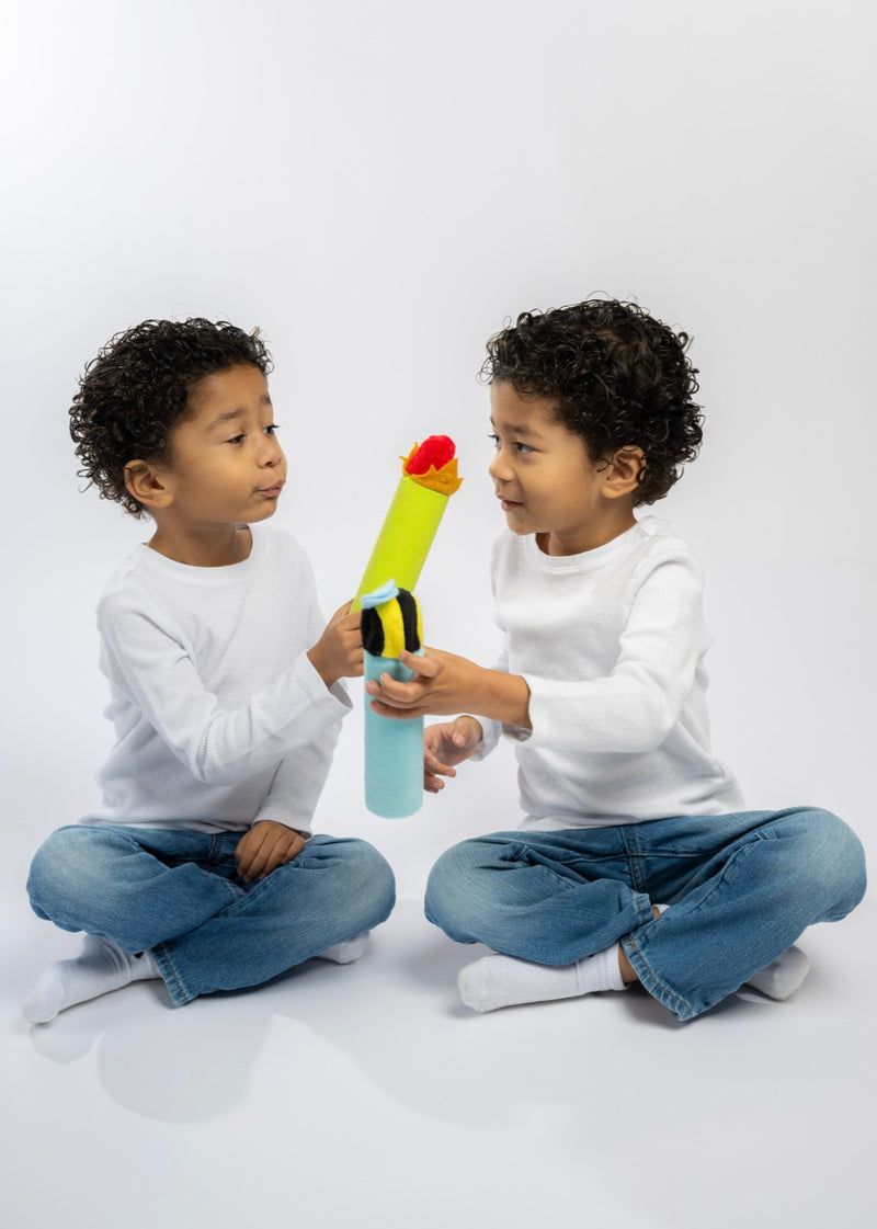 Two boys facing each other passing a breathing tube between them