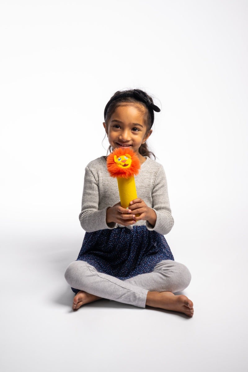 A girl holding Rory Junior upright in both hands