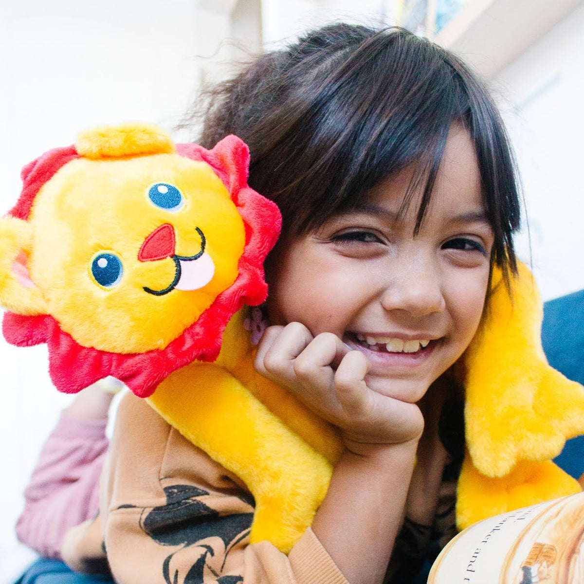 A child pressing Rory’s face to make him roar