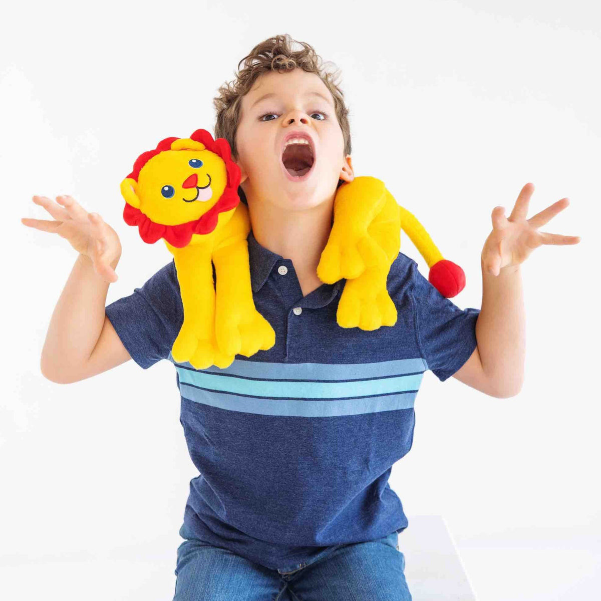 Rory the Lion held between an adult and a child