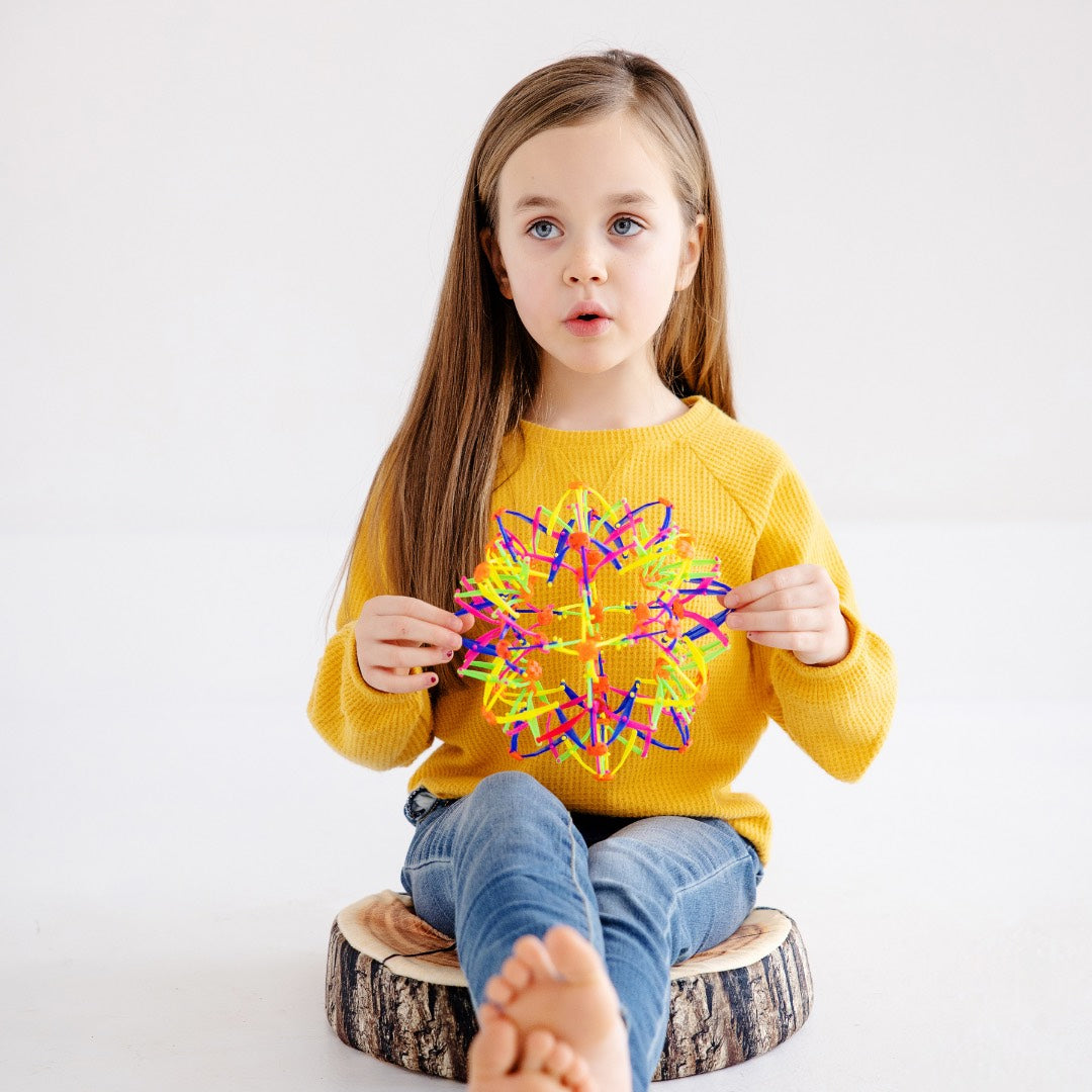 A girl sitting cross-legged on Stumpy