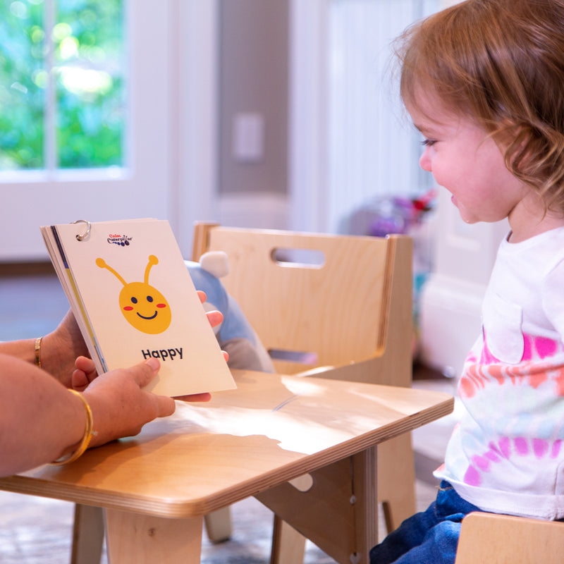 Image showing Calm Caterpillar's feelings & emotions flashcards for kids. The happy card is being shown to the child.