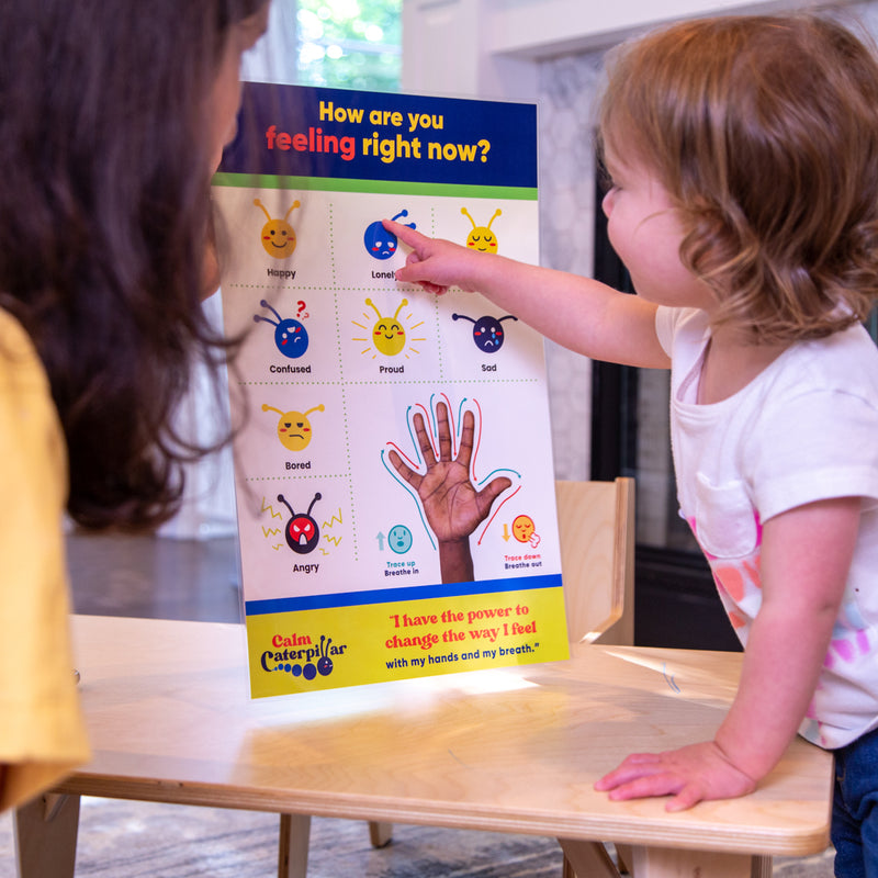 Image showing a child interacting with the calm caterpillar feelings & emotions chart.