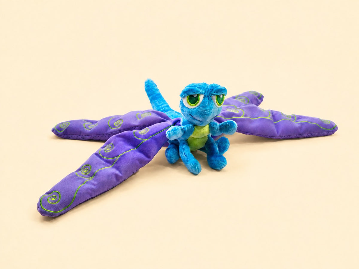 Flutter laid flat with all four wings spread, on cream