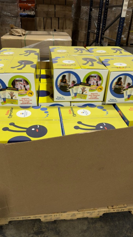Pallets of finished Calm Corner Kit boxes ready to ship from the warehouse.