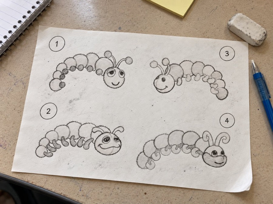 A pencil sketch sheet with four numbered caterpillar face and body studies.